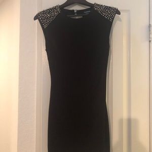 Bebe’s studded open back black dress.
